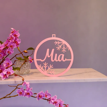 Pink Mia acrylic Christmas name ornament on a display stand