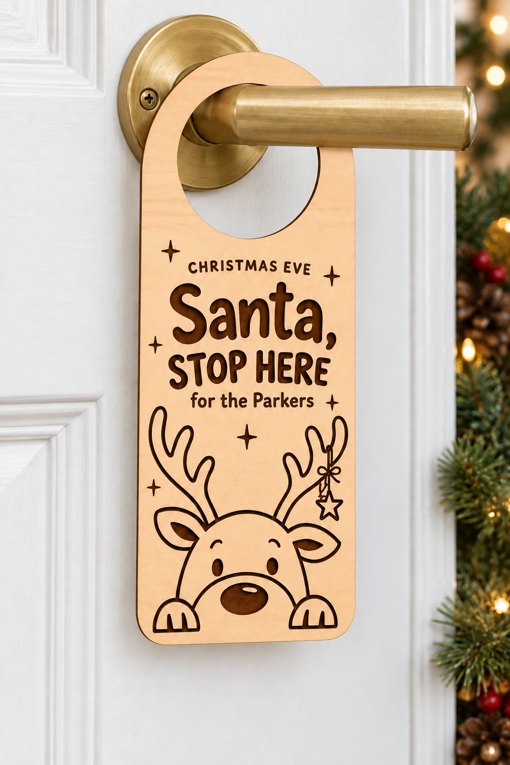 Personalised wooden Santa Stop Here door hanger for the Parkers on a white door, with reindeer engraving and a closed hoop