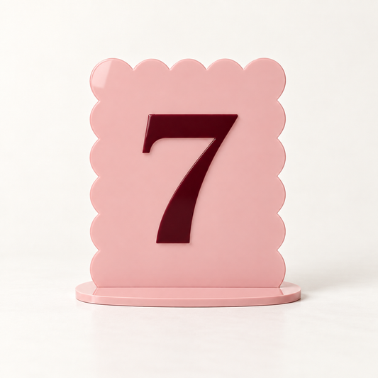 Blush pink scalloped acrylic table number 7 with raised burgundy numeral and matching base